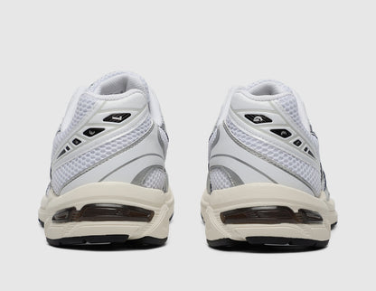 ASICS GEL-1130. Rear view of pair of white running shoes showing cloud grey heel overlays and GEL midsole inserts. 