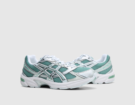 ASICS GEL-1130. Three-quarter view of pair of verdigris teal running shoes showing open mesh upper, pure silver overlays, and white laces. 