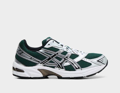 ASICS GEL-1130. Side view of running shoes featuring an evergreen mesh base upper with metallic silver synthetic overlays, black-outlined ASICS tiger stripes, white EVA foam midsole with GEL technology cushioning, and dark TRUSSTIC midfoot support system. 