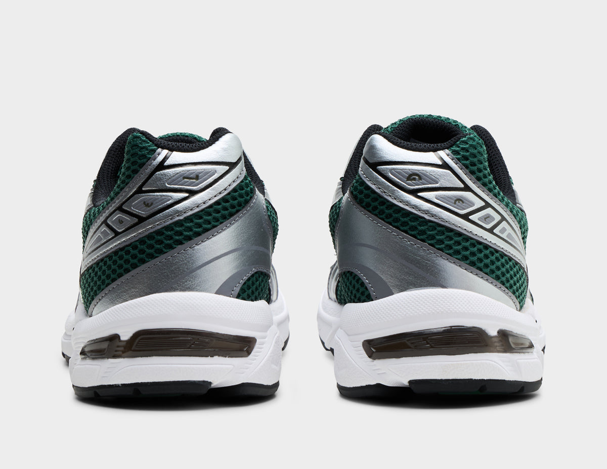 ASICS GEL-1130. Rear view of pair of running shoes showing evergreen mesh heels, metallic silver overlays, black collar lining, and visible GEL technology window in the white midsole. 