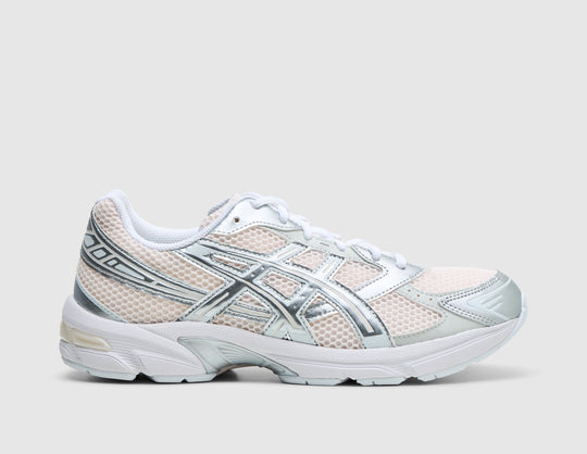 ASICS GEL-1130. Side view of running shoes featuring a blush pink mesh base upper with metallic pure silver synthetic leather overlays, signature ASICS tiger stripes, off-white GEL-cushioned midsole, and TRUSSTIC support system. 