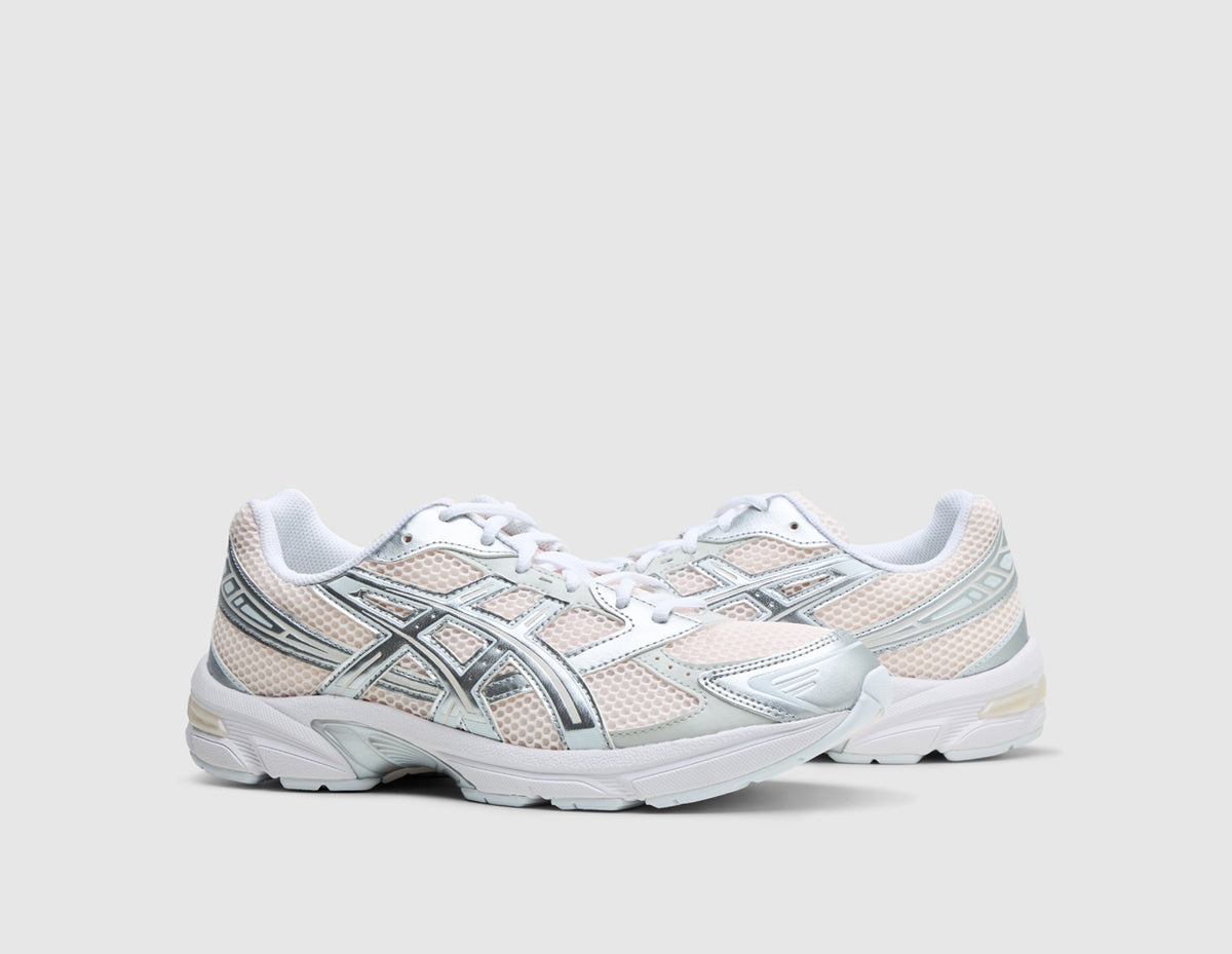 ASICS GEL-1130. Three-quarter view of pair of running shoes showing blush pink mesh uppers, metallic pure silver overlays, white laces, and off-white midsoles. 