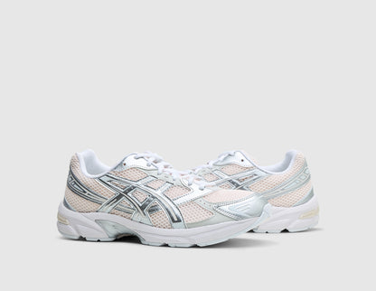 ASICS GEL-1130. Three-quarter view of pair of running shoes showing blush pink mesh uppers, metallic pure silver overlays, white laces, and off-white midsoles. 