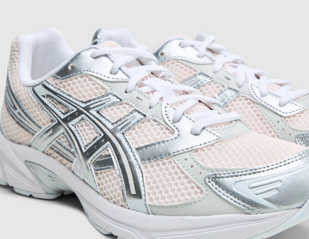 ASICS GEL-1130. Close-up three-quarter view of forefoot showing blush pink mesh toe box, metallic pure silver overlays, white eyelets, and white laces. 