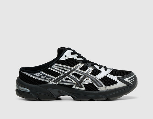 ASICS GEL-1130 Mule. Side view of black mesh backless mules featuring metallic graphite grey synthetic overlays, and GEL cushioned sole. 