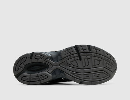 ASICS GEL-1130 Mule. Bottom view of single black backless mule showing rubber traction outsole pattern with central TRUSSTIC support unit. 