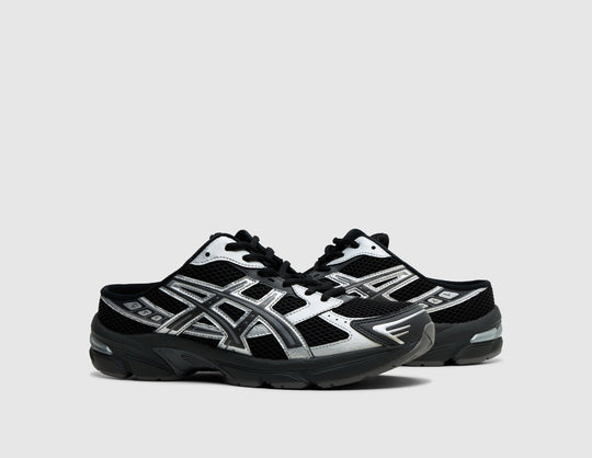 ASICS GEL-1130 Mule. Three-quarter view of pair of black backless mules showing metallic graphite grey overlays, and black laces. 
