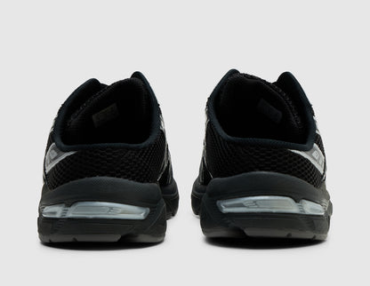 ASICS GEL-1130 Mule. Rear view of pair of black backless mules showing low backless heel entry and GEL midsole inserts. 