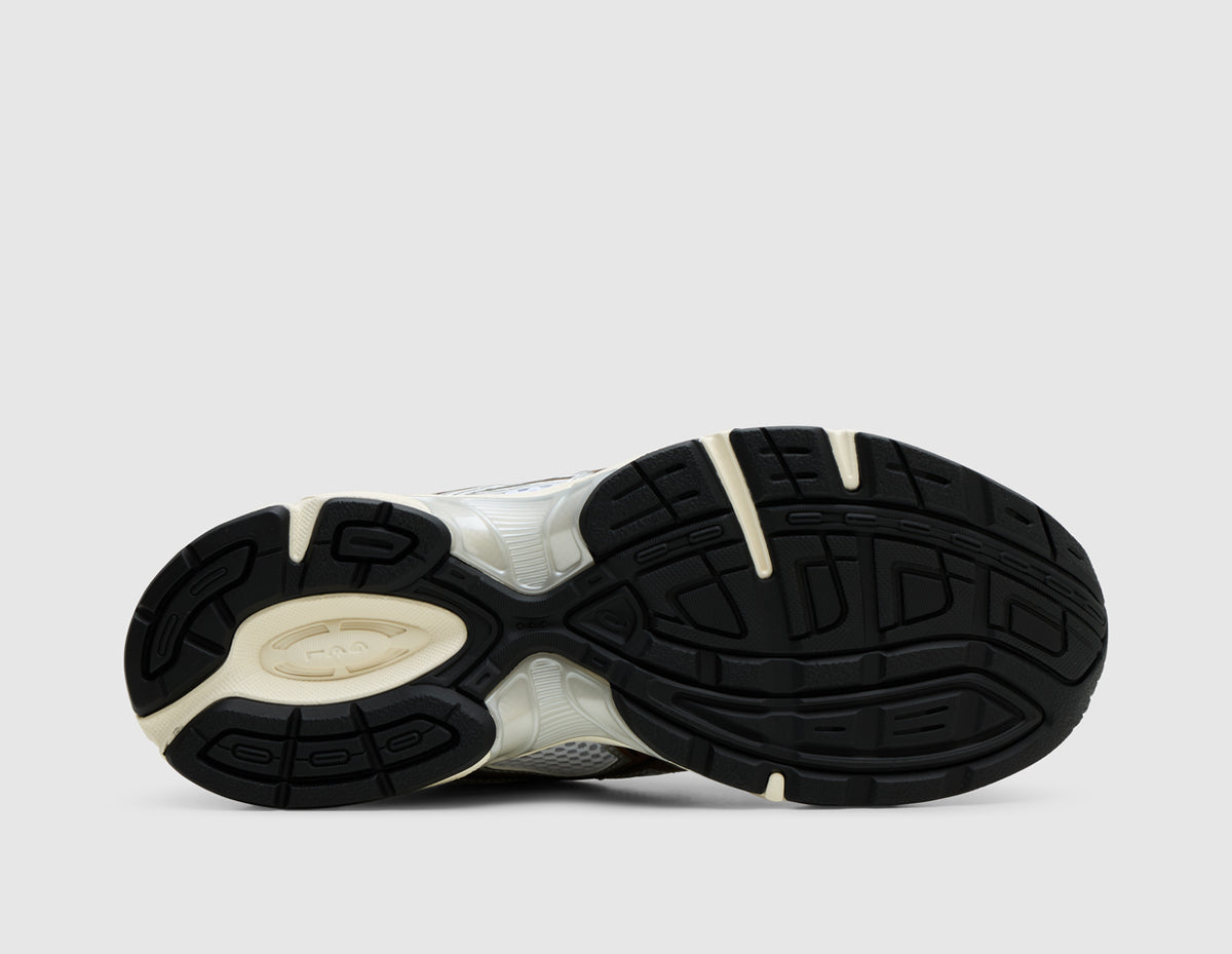 ASICS GEL-1130 Mule. Bottom view of white open-back mule sneaker showing black rubber traction outsole pattern and cream midsole. 