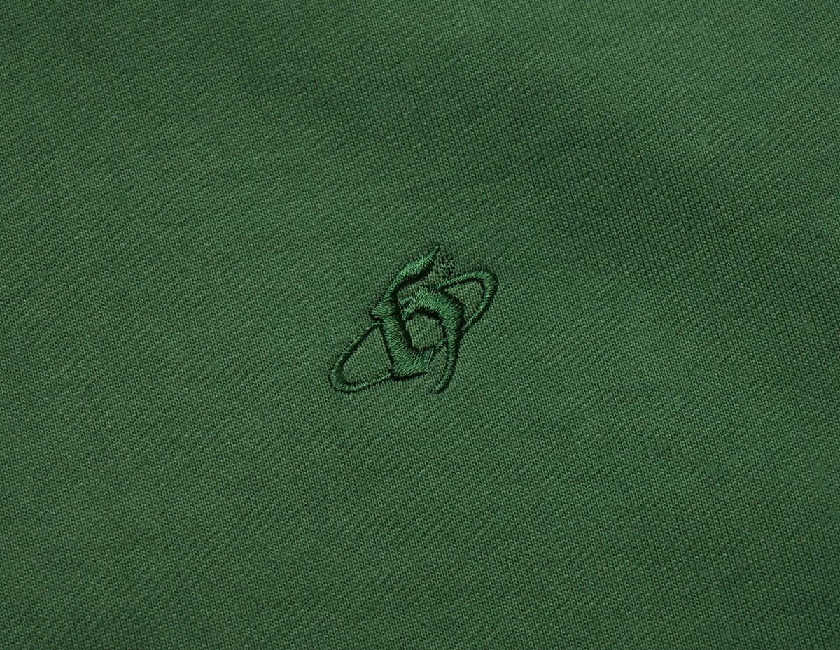 Home Grown Brutal HD Hoodie. Close-up of dark ivy green fleece showing tonal embroidered “h” logo on the chest. 