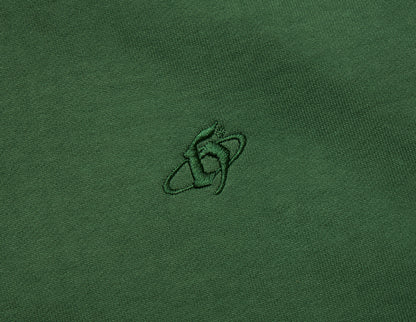 Home Grown Brutal HD Hoodie. Close-up of dark ivy green fleece showing tonal embroidered “h” logo on the chest. 