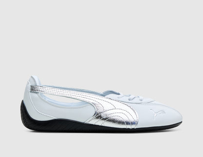 PUMA Women's Speedcat Nova. Side view of PUMA white leather ballet flat sneakers featuring metallic silver Formstrip overlay, cut-out quarter panel, metallic silver toe logo, and low-profile black driver heel. 