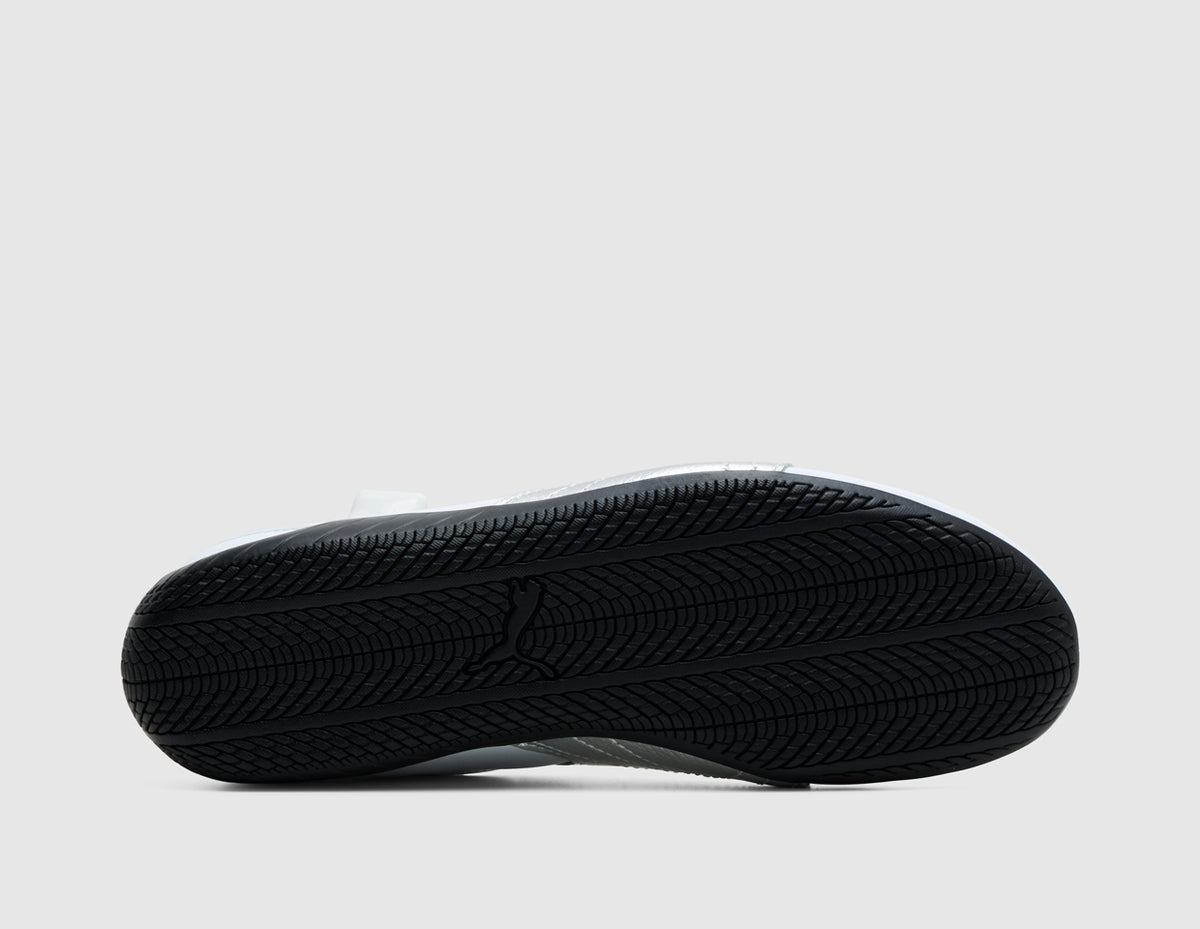 PUMA Women's Speedcat Nova. Bottom view of single PUMA white ballet flat sneaker showing low-profile black tread rubber outsole. 