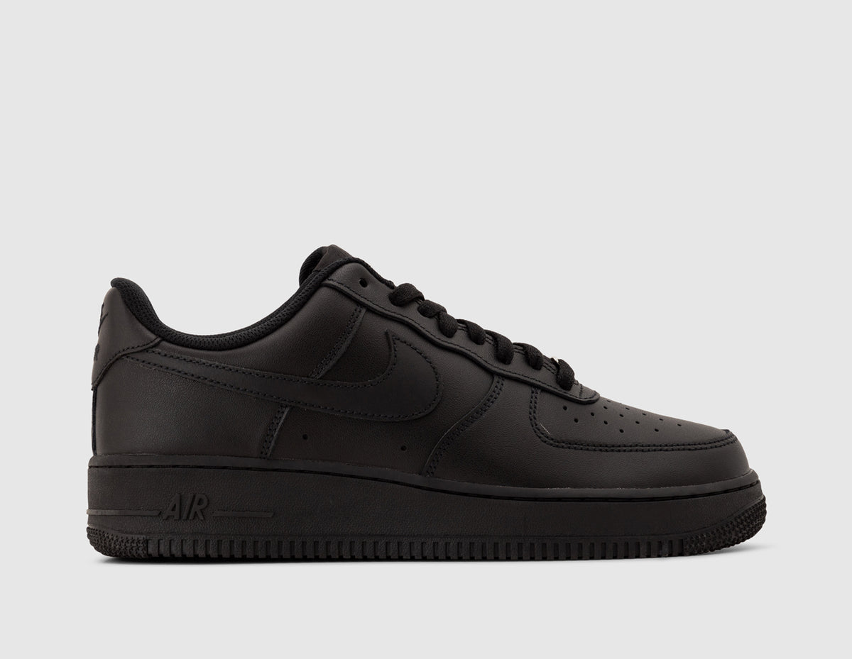 Nike Air Force 1 '07. Side view of all-black leather sneakers showing tonal Nike Swoosh and AIR branded midsole. 