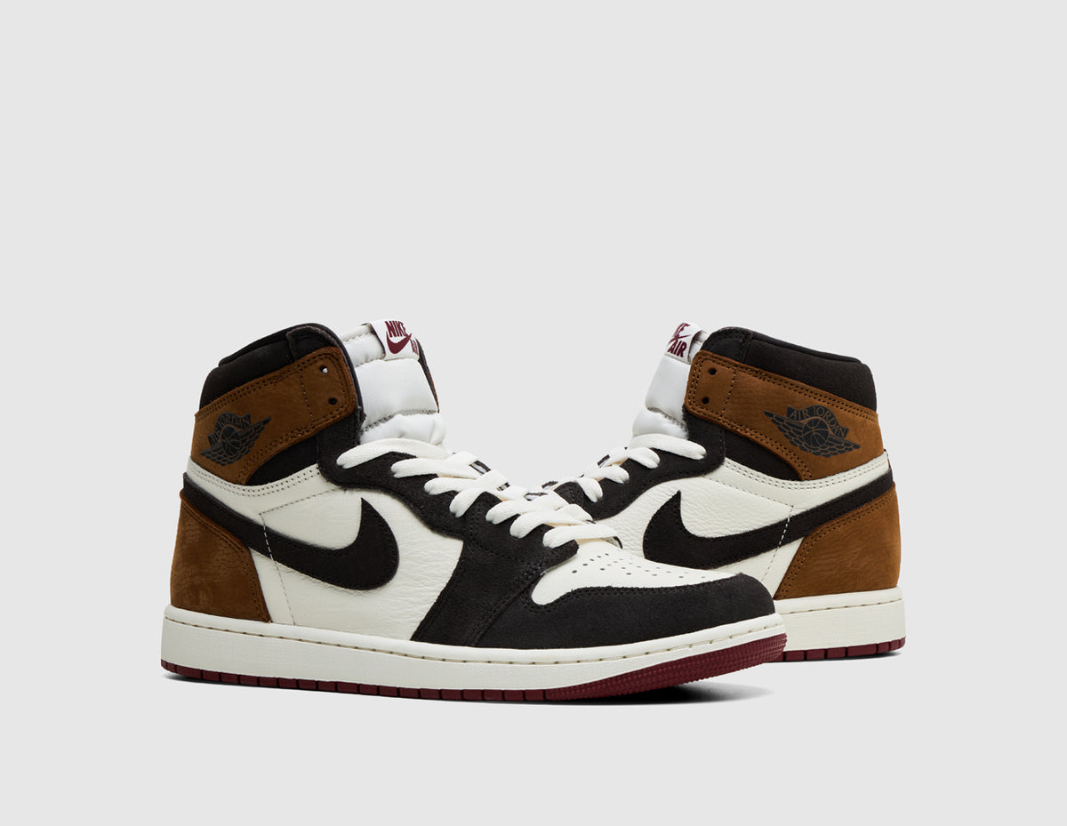 Jordan 1 Retro High OG "Love Letter". Three-quarter view of pair of high-top sneakers showing shadow brown suede collar, black suede overlays, and sail laces. 