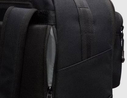 Nike Utility Speed Backpack (27L). Close-up view of the side showing zippered expandable sleeve pocket designed for water bottle storage. 