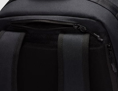 Nike Utility Speed Backpack (27L). Close-up view of top zippered fleece-lined media/valuables pocket located above the back straps. 