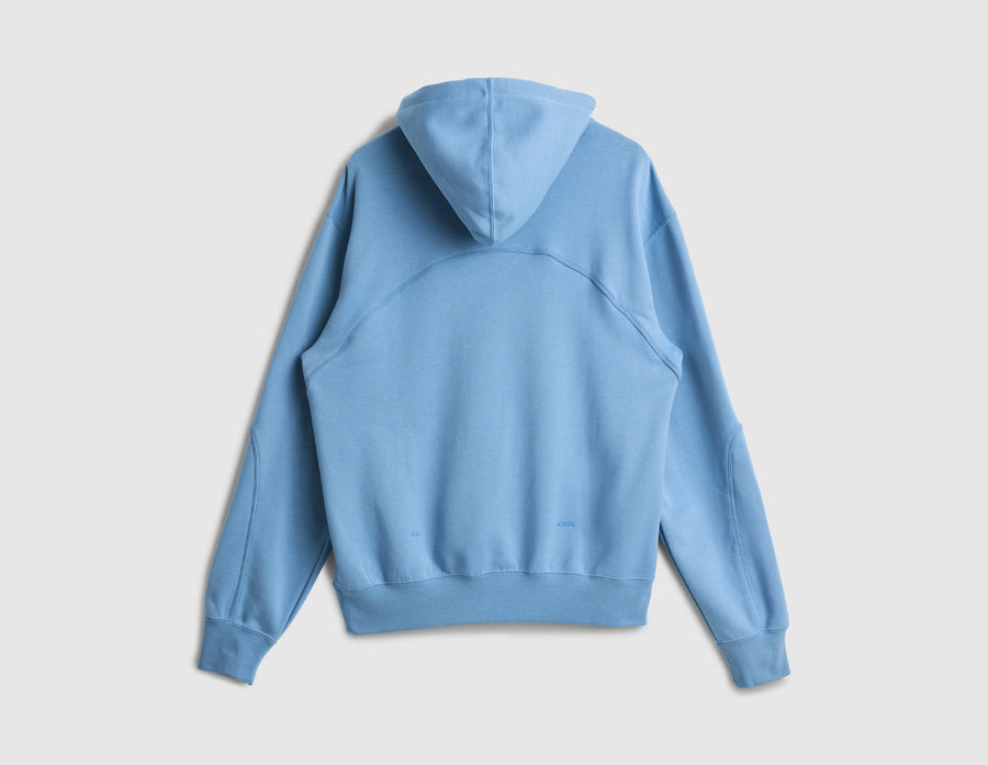 Nike NOCTA Fleece CS Hoodie. Back view of work blue pullover hoodie showing attached hood and ribbed hem cuff. 