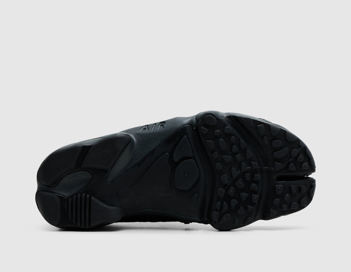 Nike Women's Air Rift. Bottom view of off-noir black split-toe shoes showing rubber traction outsole pattern and split-toe groove. 