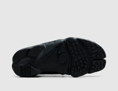 Nike Women's Air Rift. Bottom view of off-noir black split-toe shoes showing rubber traction outsole pattern and split-toe groove. 