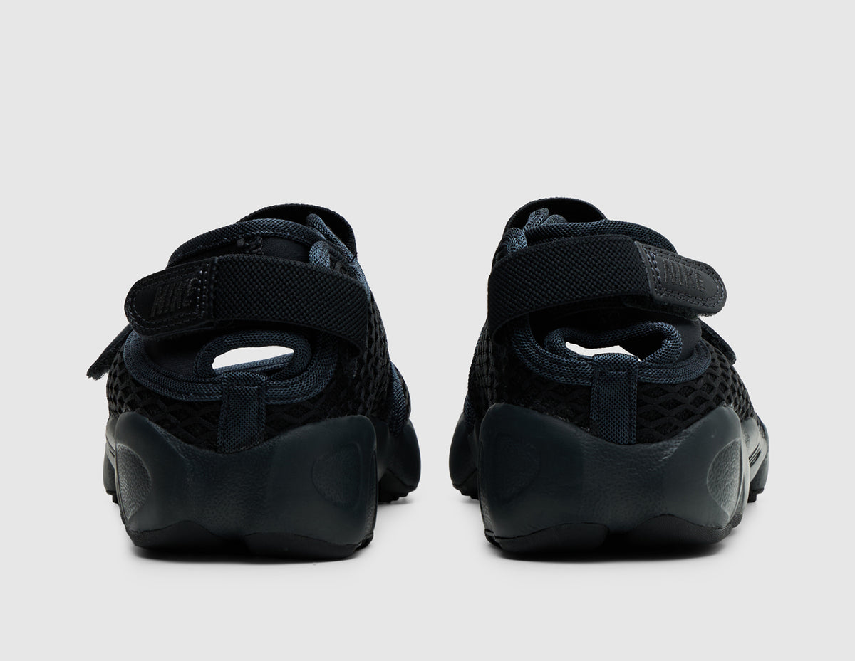 Nike Women's Air Rift. Rear view of off-noir black split-toe shoes showing adjustable hook-and-loop heel straps and sculpted midsoles. 