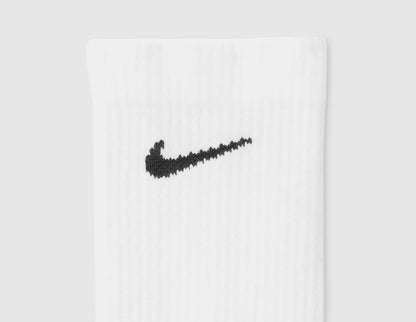 Nike Everyday Elevated Crew Socks (6-Pack). Close-up of white ribbed cuff showing black Nike Swoosh logo. 