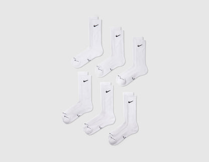 Nike Everyday Elevated Crew Socks (6-Pack). Front angle view of six pairs of white crew socks displaying black Nike Swoosh logos. 
