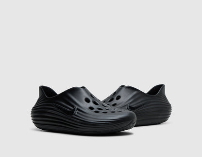 Nike ReactX Rejuven8. Three-quarter view of pair of black molded foam slip-on shoes showing perforated toe box ventilation. 