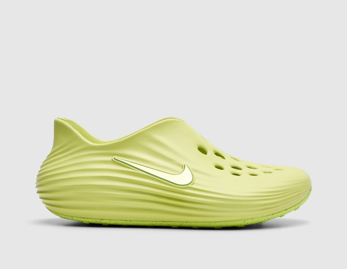 Nike Women's ReactX Rejuven8. Side view of light lemon twist foam mule slip-on shoes featuring sculpted wavy side grooves, forefoot ventilation port perforations, contrasting Swoosh logo, and thick integrated foam sole unit. 