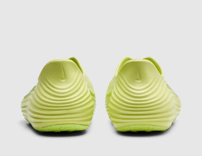 Nike Women's ReactX Rejuven8. Rear view of pair of light lemon twist foam mule slip-on shoes showing wave-textured sculpted heel counters and exaggerated padded collar lip. 