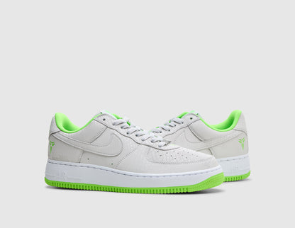 Nike Kobe Air Force 1 Low. Three-quarter view of pair of vast grey sneakers showing tonal leather Swoosh, vast grey laces, electric green inner lining, and white soles. 
