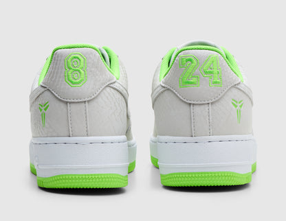 Nike Kobe Air Force 1 Low. Rear view of pair of vast grey sneakers showing electric green embroidered numbers "8" and "24" on back heel tabs, Kobe Sheath logos on lateral heels, and white Air midsoles. 