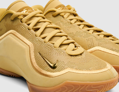 Nike LeBron XXIII "Honor Society". Close-up of wheat gold mesh knit upper, matching laces, toe guard, and metallic Swoosh logo. 