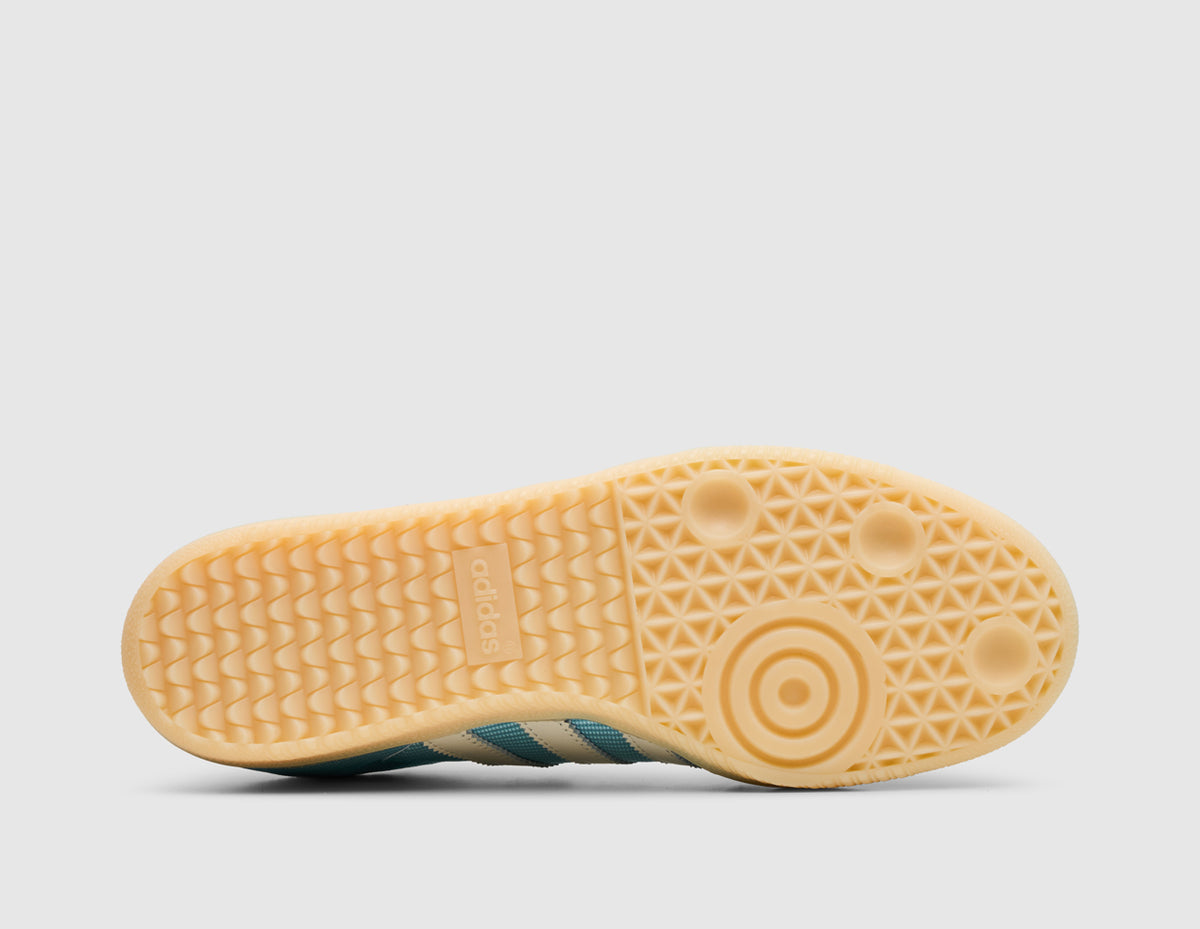 adidas Originals Samba OG. Bottom view of icy blue sneaker showing light brown gum rubber traction outsole pattern. 