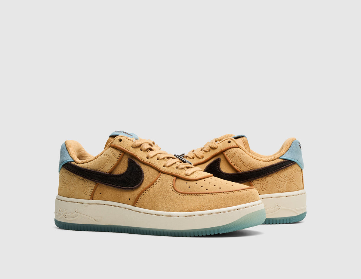Nike Kobe Air Force 1 Low Protro. Three-quarter view of pair of low-top sneakers showing twine suede uppers, baroque brown Swoosh logos, light blue heel tabs, and semi-translucent blue outsoles. 
