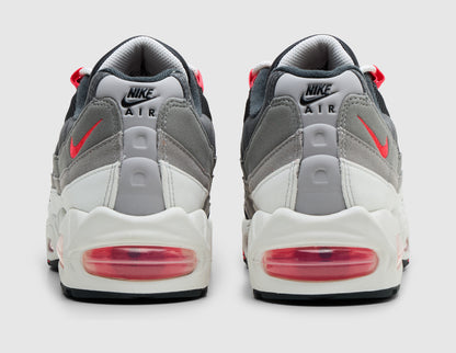 Nike Air Max 95 OG Big Bubble. Rear view of pair of reverse grey and anthracite gradient sneakers showing light grey heel tabs with black Nike Air logos, solar red mini Swooshes, and large solar red Air cushioning units. 