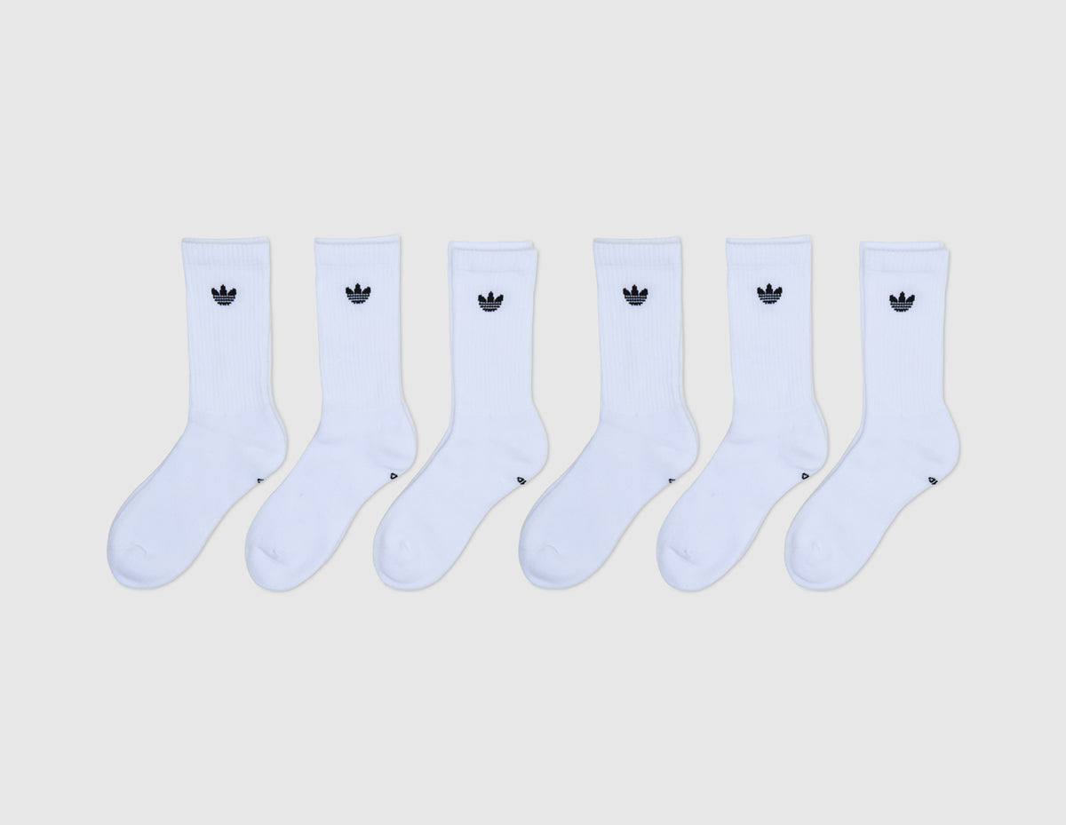 adidas Originals Trefoil 2.0 Crew Socks (6-Pack). Front flat lay view of six white ribbed crew socks lined up, each featuring a small jacquard knit adidas Trefoil logo on the upper ankle cuff. 