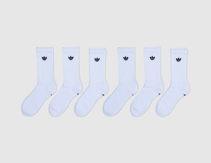 adidas Originals Trefoil 2.0 Crew Socks (6-Pack). Front flat lay view of six white ribbed crew socks lined up, each featuring a small jacquard knit adidas Trefoil logo on the upper ankle cuff. 