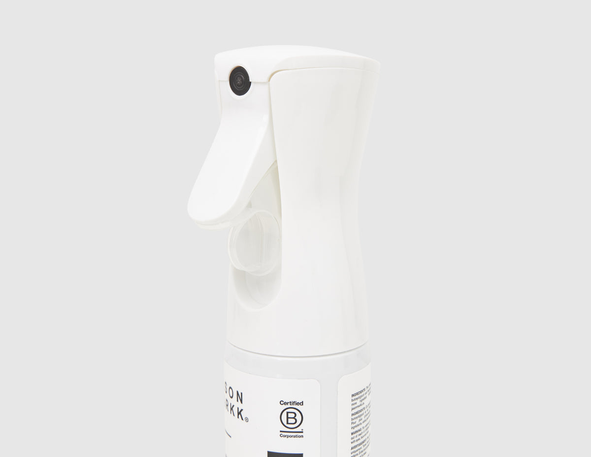 Jason Markk 5.4 oz. Repel Spray. Close-up view of white ergonomic trigger spray nozzle and bottle neck. 