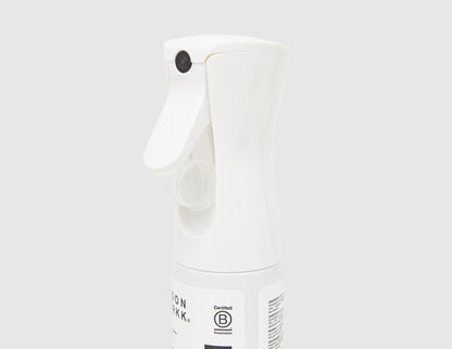 Jason Markk 5.4 oz. Repel Spray. Close-up view of white ergonomic trigger spray nozzle and bottle neck. 