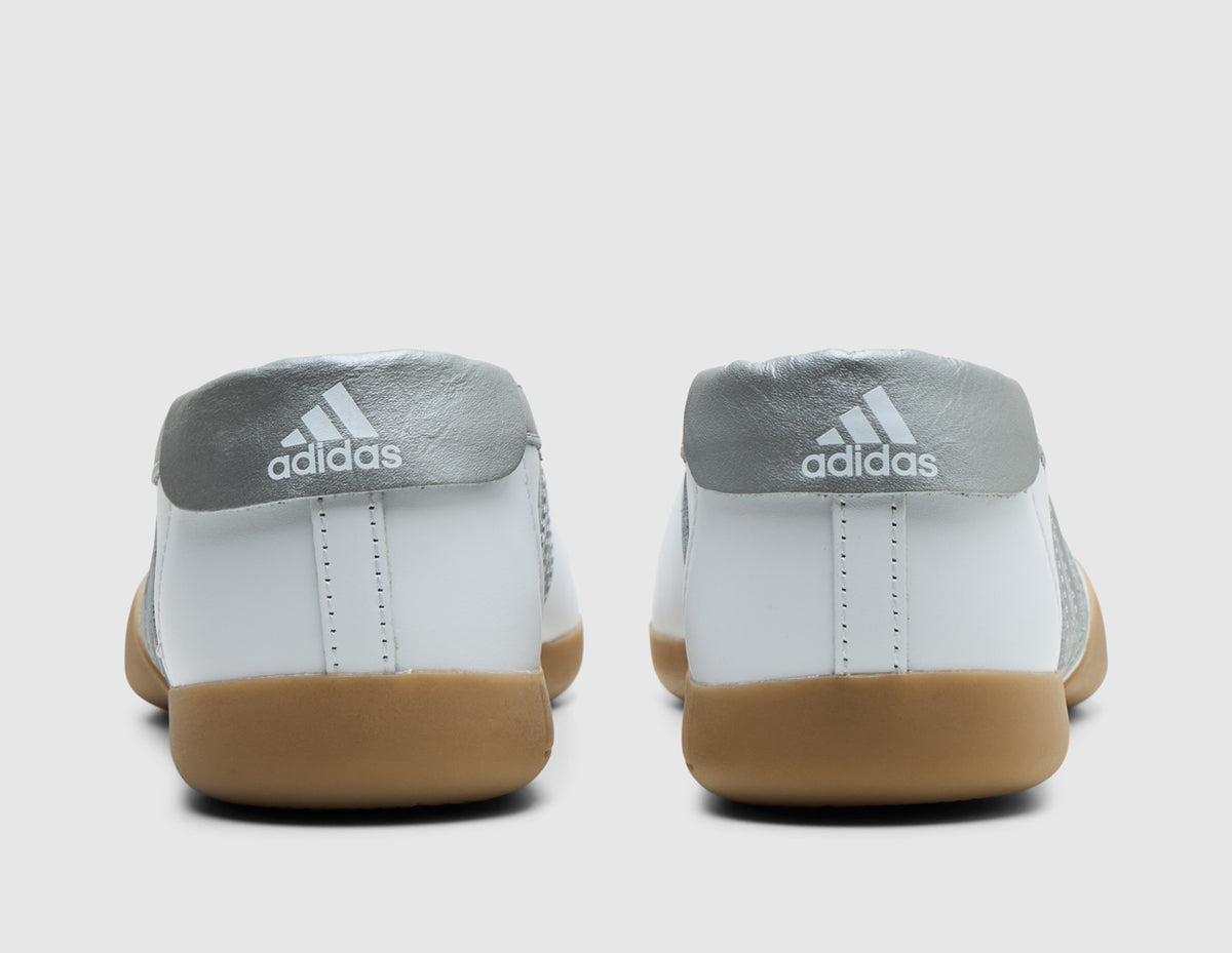 adidas Originals Women's Taekwondo Mei Ballet. Rear view of white leather slip-on shoes showing metallic silver heel overlays with white adidas Trefoil logos. 