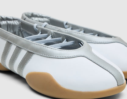 adidas Originals Women's Taekwondo Mei Ballet. Close-up of white leather upper showing metallic silver trim collar, toe seam, optional lace detailing and three-stripes. 