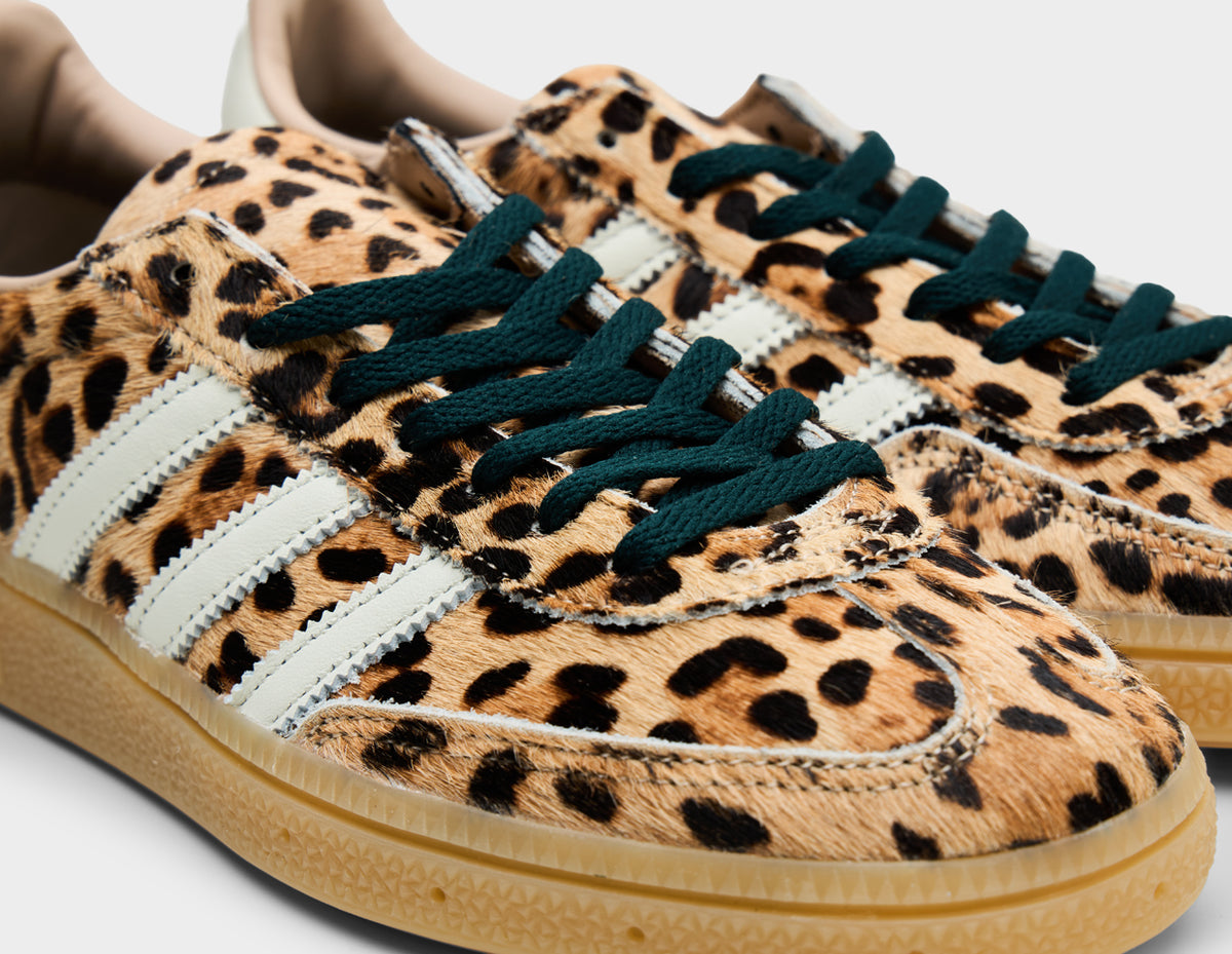 adidas Women's Handball Spezial. Close-up of leopard print faux fur upper, black laces, T-toe overlay, and white three-stripes. 