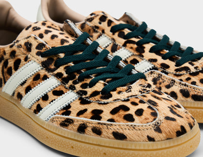 adidas Women's Handball Spezial. Close-up of leopard print faux fur upper, black laces, T-toe overlay, and white three-stripes. 