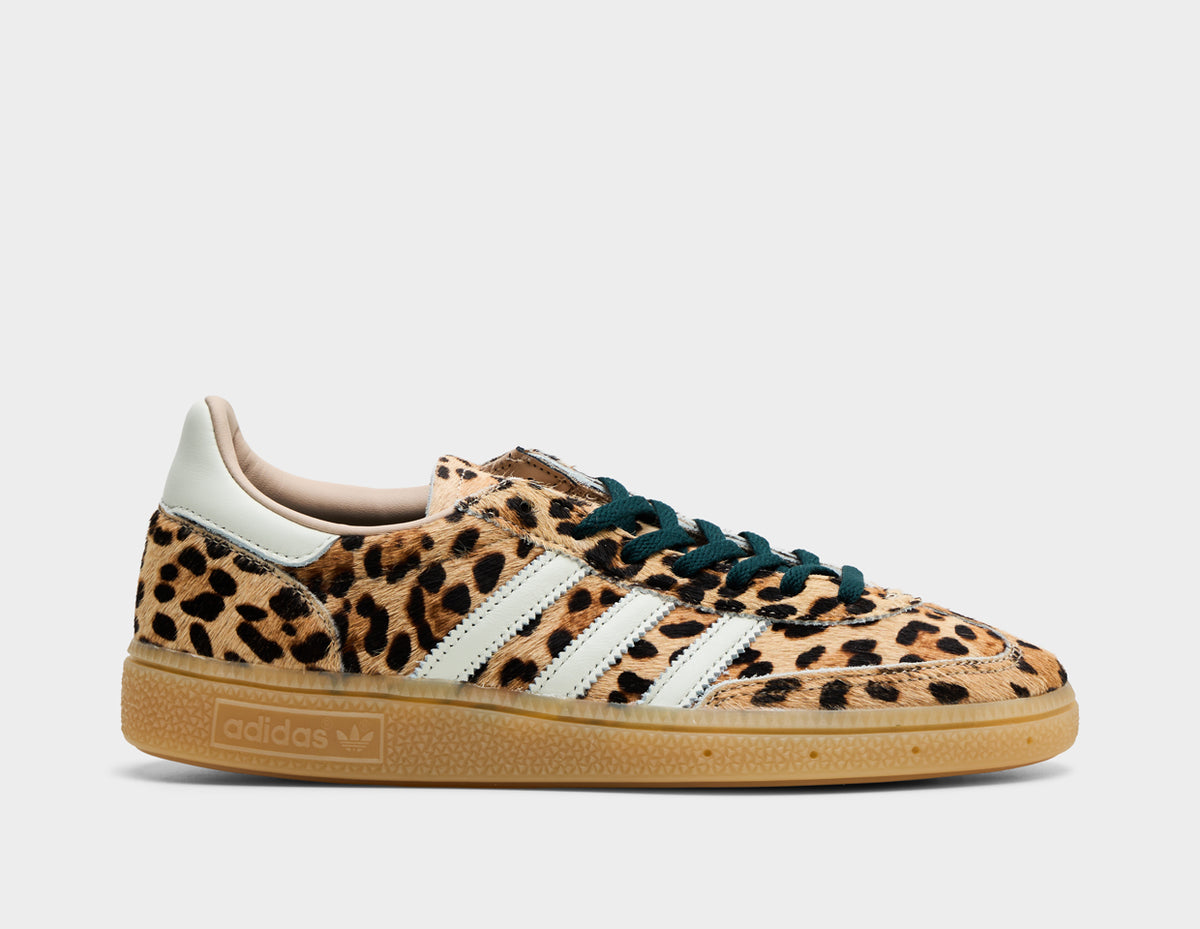 adidas Women's Handball Spezial. Side view of leopard print sneakers with white three-stripes, black laces, and gum rubber sole. 