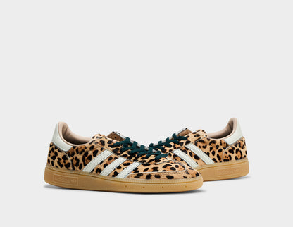 adidas Women's Handball Spezial. Three-quarter view of leopard print sneakers showing black lace closure and gum rubber sole. 