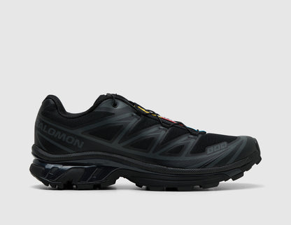 Salomon XT-6. Side view of triple black trail running shoes featuring phantom synthetic overlays, black Salomon branding, and lugged sole. 