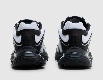 Salomon XT-Whisper. Rear view of pair of black and white trail running shoes showing white heel collar trim and black heel counters with glossy support overlays. 