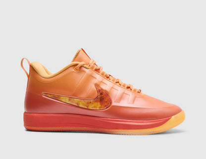 Nike Book 2 "The Phoenix". Side view of sundial orange basketball shoes featuring gradient orange-to-red upper, flame-graphic Swoosh, red Cushlon midsole, and translucent gum rubber outsole. 