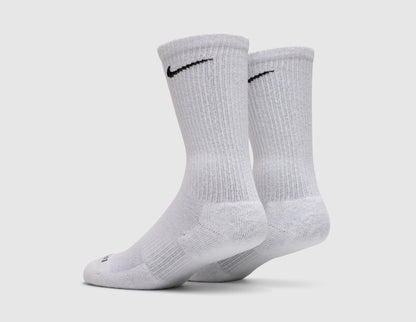 Nike Everyday Plus Cushioned Socks (3-Pack). Back three-quarter view of pair of white crew socks showing black Swoosh logos and ribbed cuffs. 